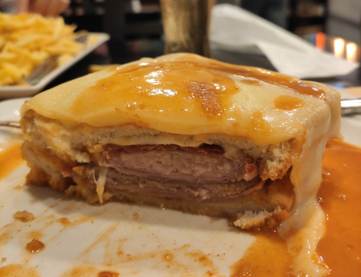 A francesinha, the layered Porto sandwich under melted cheese and sauce