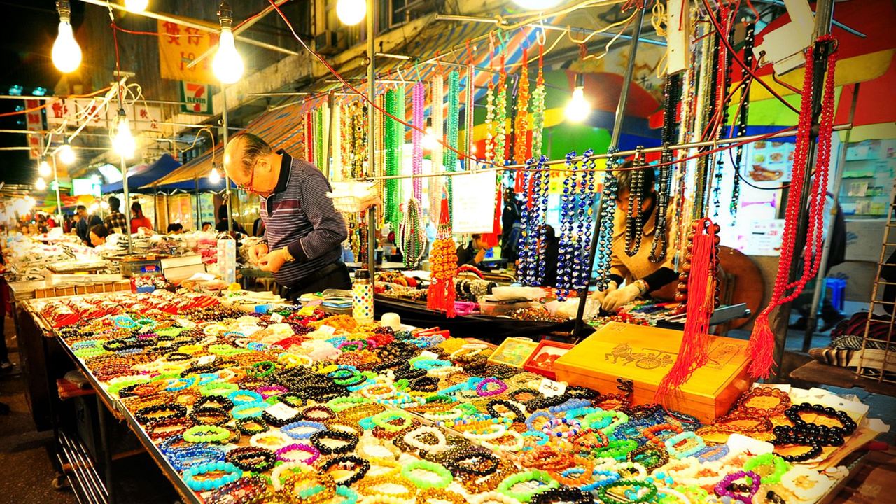 A lit stall of beads and trinkets at the Temple Street night market