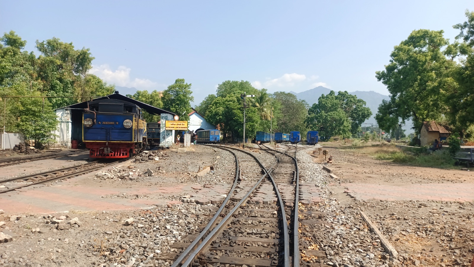 The blue Nilgiri Mountain Railway train in the yard at the foot of the climb to Ooty.