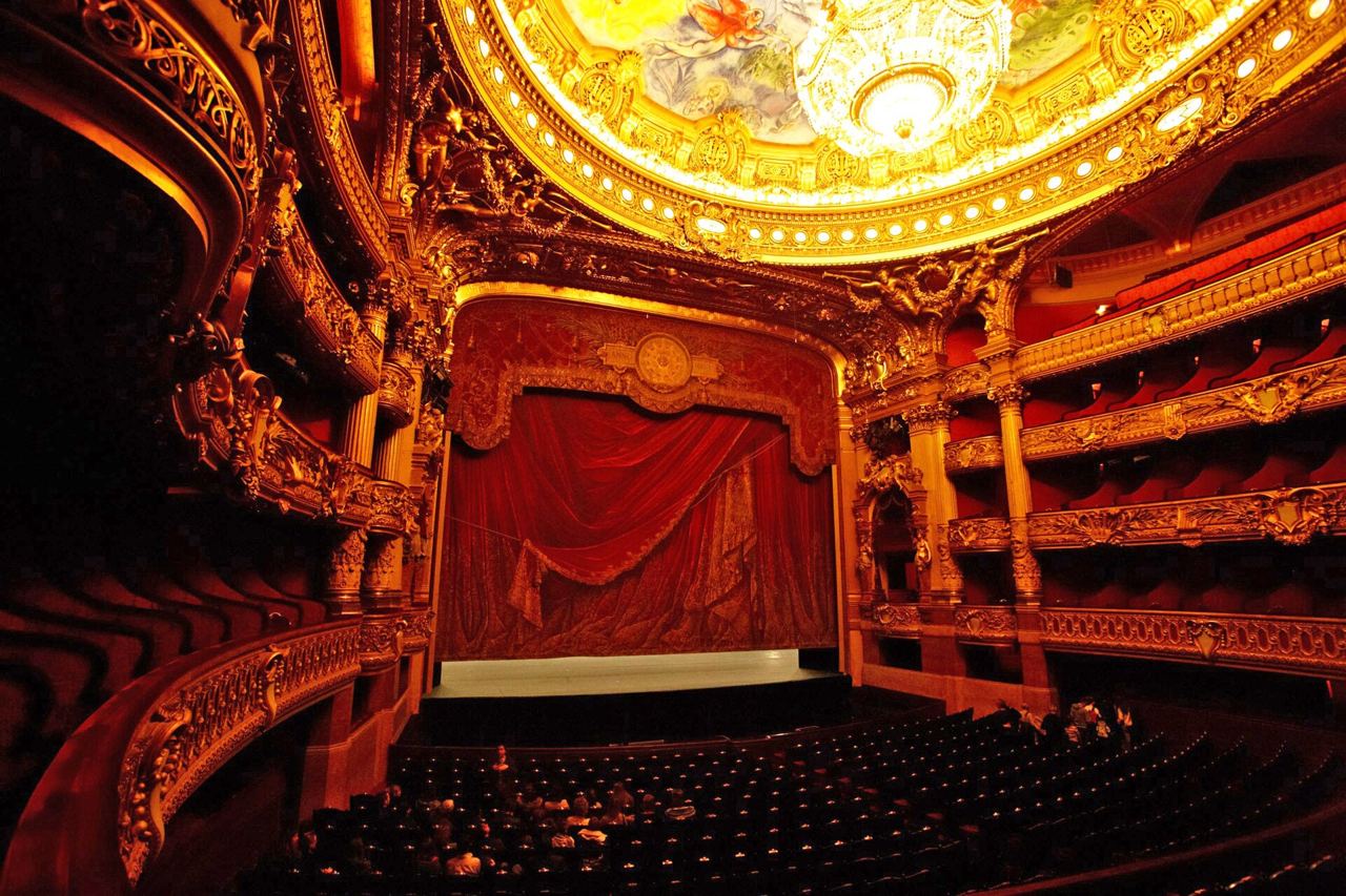 The gilded auditorium and stage of the Palais Garnier in Paris