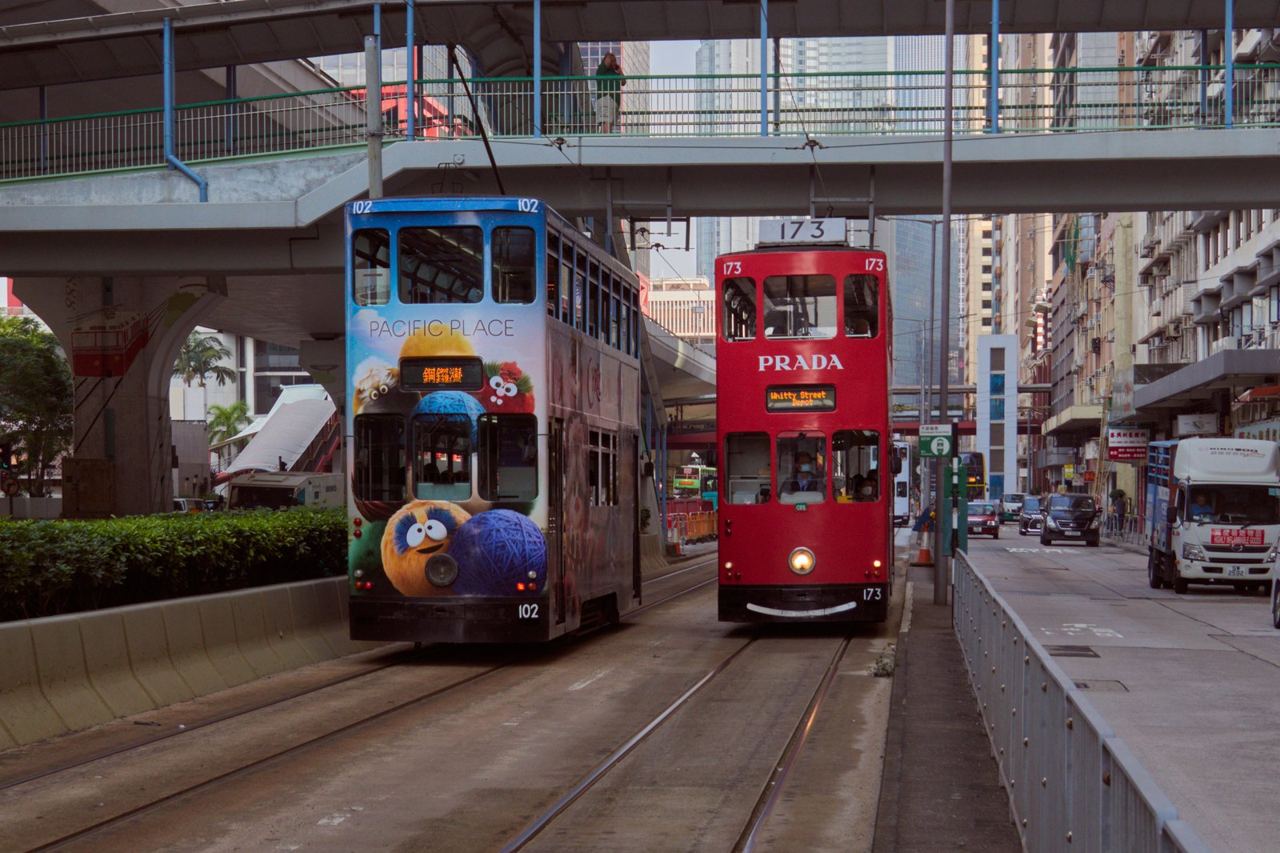 Two double-deck Hong Kong trams passing on the tracks in Central