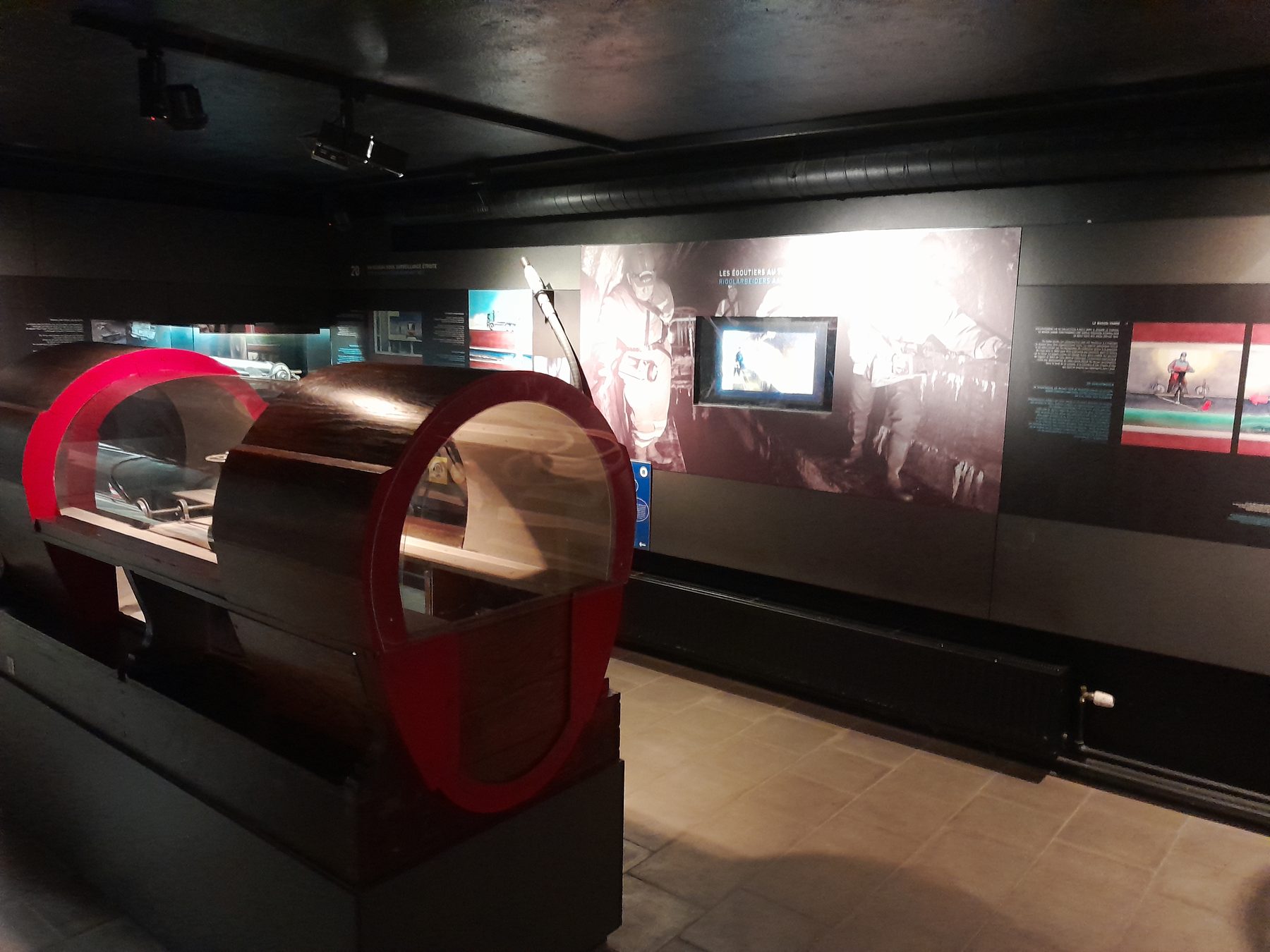 Interior of the Brussels Sewer Museum with a tunnel section below the exhibits