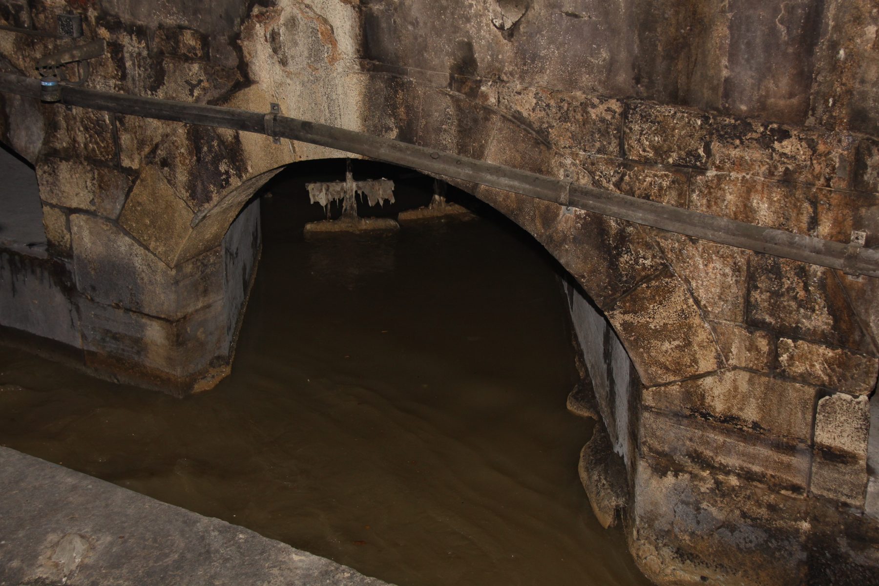 A lit brick sewer tunnel in Vienna on the Third Man tour route